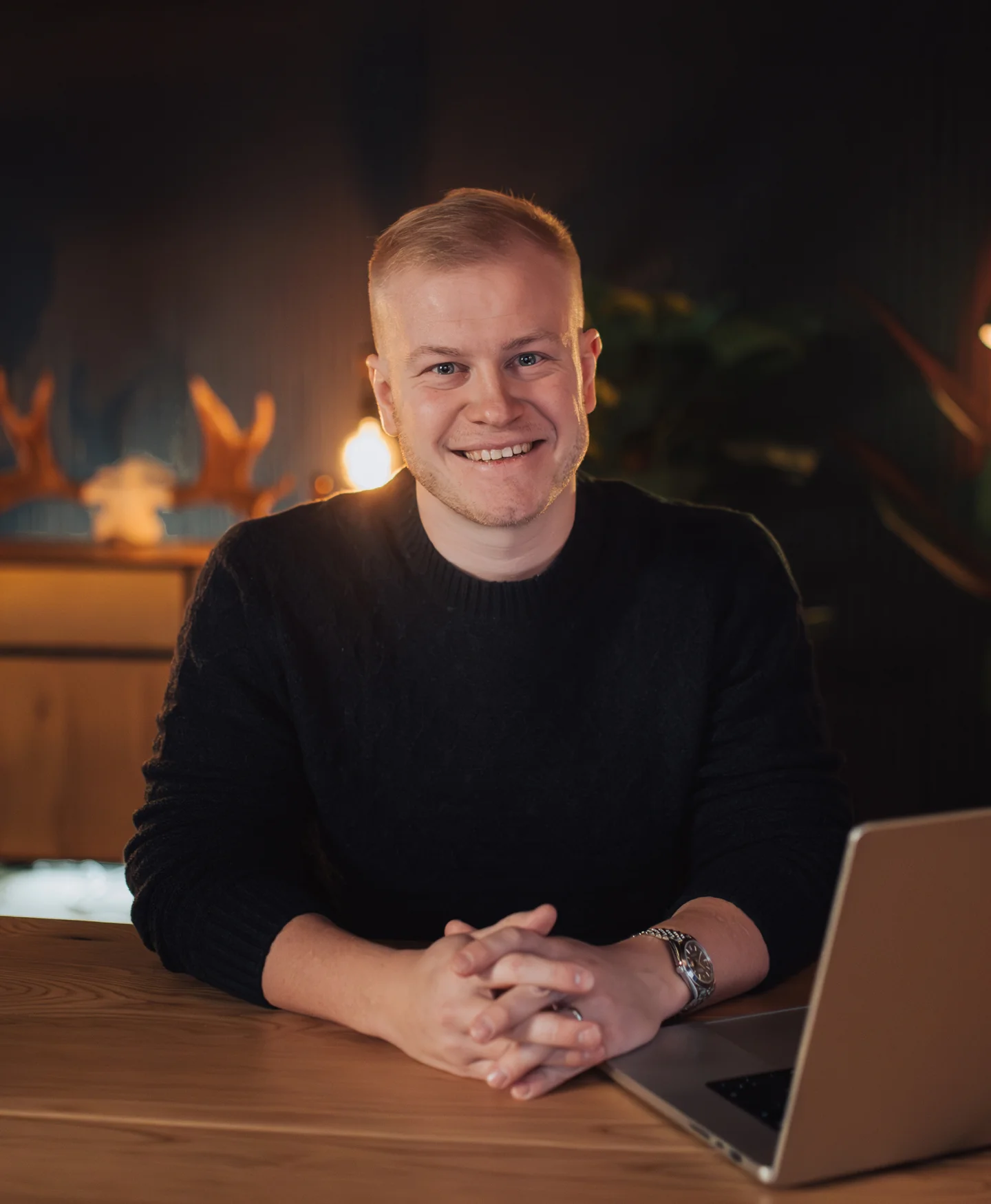Gusten Sun, founder of PersonalBrand.so, smiling at a studio desk